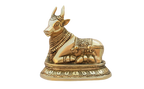 Golden-toned Nandi Ji murti on an ornate pedestal