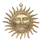 Ornate golden sun face wall hanging with decorative circular rays