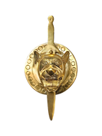 Golden lion face wall hanging with sword motif