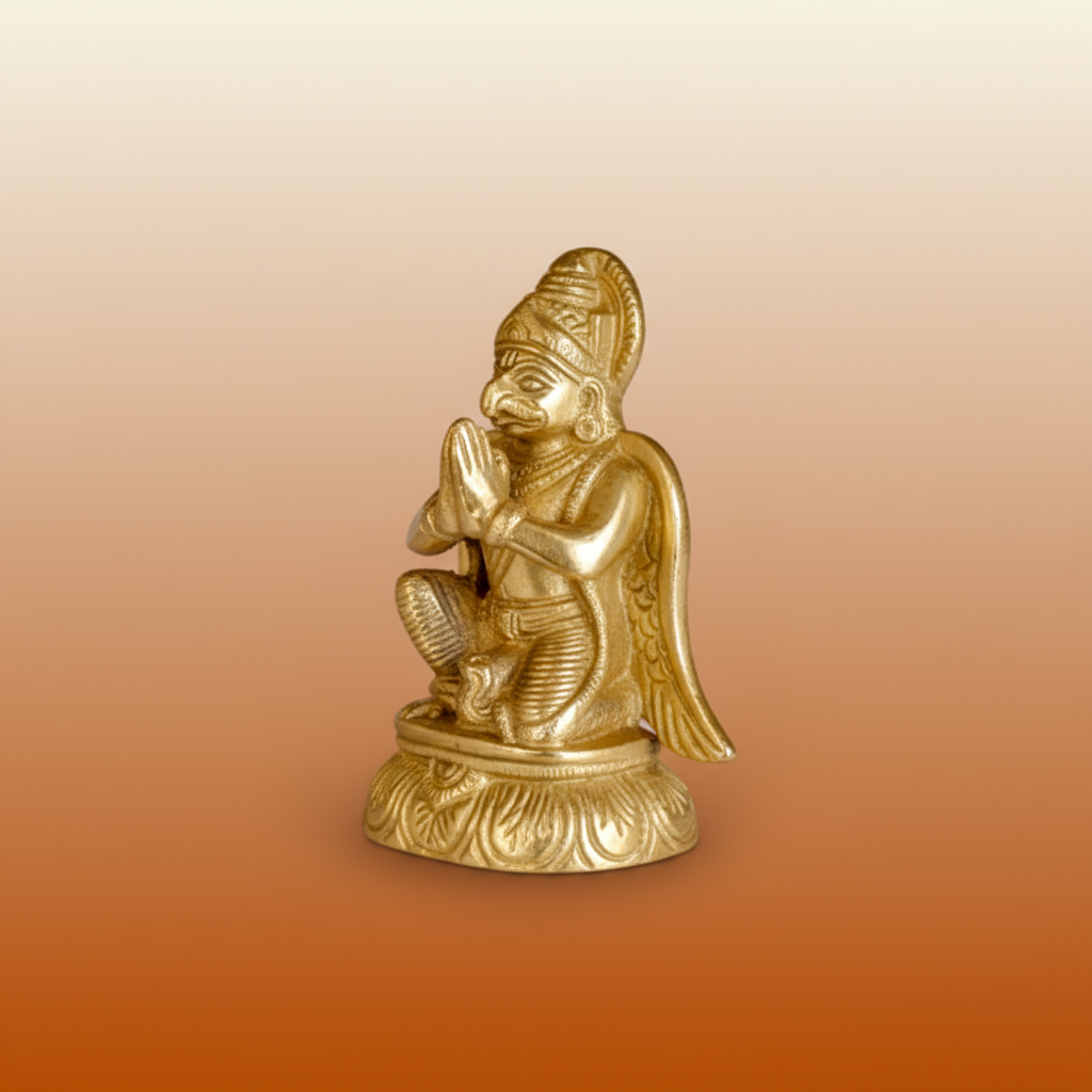 Garud Dev golden statue on a warm devotional studio background