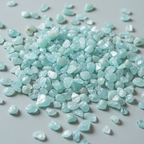 Close-up of natural Aquamarine tumbled stones and pale aqua crystal chips