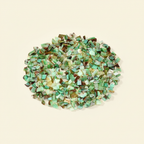 Natural green Chrysoprase crystal chips arranged on an ivory background
