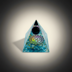 Black Tourmaline crystal pyramid with a central circular motif on a charcoal and ivory background
