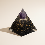 Side profile of a black tourmaline crystal pyramid with gold flecks and purple crystal