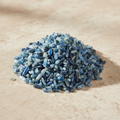 Kyanite Crystal Chips arranged on a warm neutral stone surface