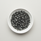 Hematite crystal chips arranged in a white ceramic dish