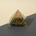 Golden Pyrite crystal pyramid with warm metallic texture on a premium studio background