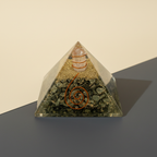 Golden Pyrite crystal pyramid with warm metallic texture on a premium studio background
