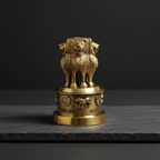 Brass Ashoka Stambh-inspired decor displayed on dark natural stone