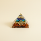 Colorful 7 Chakra Yantra crystal pyramid with central yantra motif on a warm ivory background