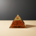 Red Jasper crystal pyramid with warm earthy red tones on a premium studio background