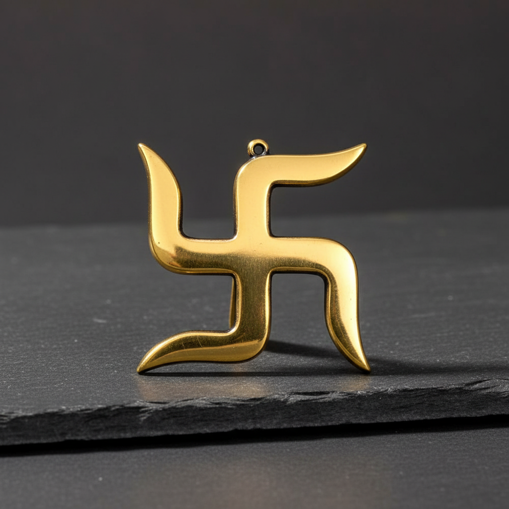 Gold-brass Swastik decor displayed on dark natural stone