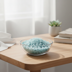 Aquamarine tumbled stones displayed in a glass dish on a calm workspace