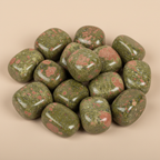 Close-up of smooth polished Unakite tumble stones with natural green and pink mottling