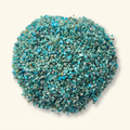 Loose Blue Apatite tumbled stones and turquoise crystal chips arranged on an ivory studio background