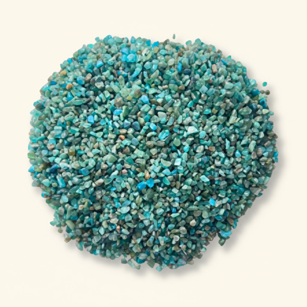 Loose Blue Apatite tumbled stones and turquoise crystal chips arranged on an ivory studio background