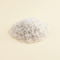 Natural translucent Clear Quartz crystal chips arranged on an ivory background