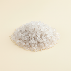 Natural translucent Clear Quartz crystal chips arranged on an ivory background
