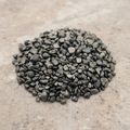 Pyrite Crystal Chips arranged on a warm neutral stone surface