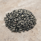 Pyrite Crystal Chips arranged on a warm neutral stone surface