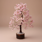 Close three-quarter view of a Rose Quartz crystal tree with pink chips and fine branches