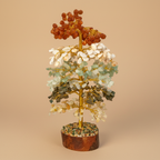 Close three-quarter view of a Multi-Color crystal tree with layered colourful stones and golden trunk