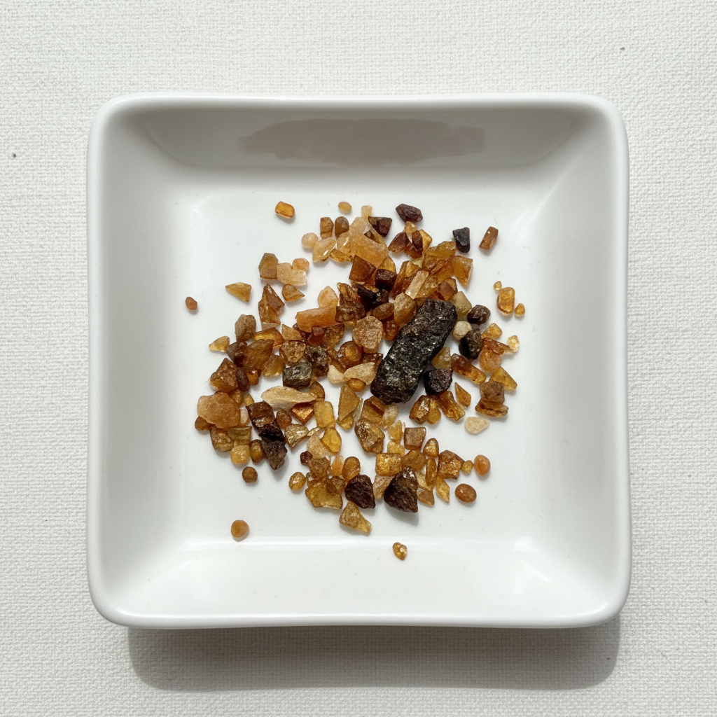 Hessonite crystal chips arranged in a white ceramic dish