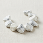 Close-up of rough white and ivory Howlite Crystal Chips with gray veining