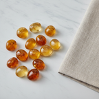 Citrine tumble stones arranged with neutral linen décor