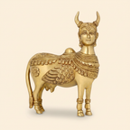 Kamdhenu Cow golden statue on a warm ivory studio background