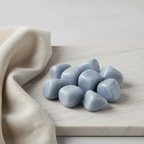 Angelite tumble stones arranged with neutral linen décor