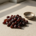 Polished Red Agate tumble stones arranged on a neutral linen surface