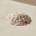 Multi-Moonstone Crystal Chips arranged on a warm neutral stone surface