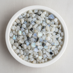 Rainbow Moonstone crystal chips arranged in a white ceramic dish