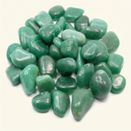 Polished green aventurine tumble stones arranged on a warm ivory background