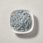 Fluorite crystal chips arranged in a white ceramic dish