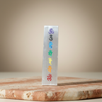 Rectangular seven chakra panel displayed on a warm terracotta and cream stone surface
