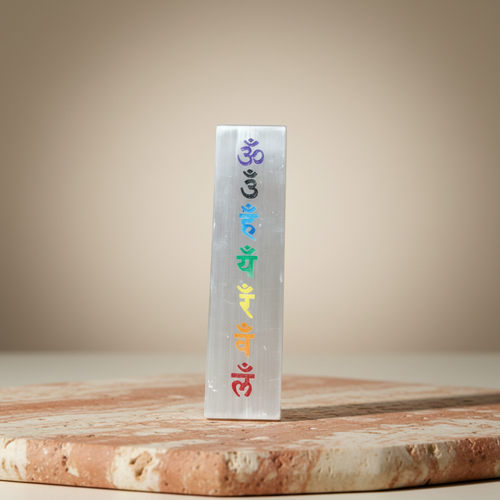 Rectangular seven chakra panel displayed on a warm terracotta and cream stone surface