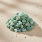Green Jade Crystal Chips arranged on a warm neutral stone surface