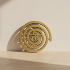 Gold-brass Helix spiral decor displayed on a warm neutral surface