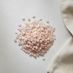 Rose Quartz crystal chips arranged with neutral linen décor