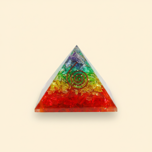 Colorful 7 Chakra crystal coil pyramid with central coil detail on a warm ivory background
