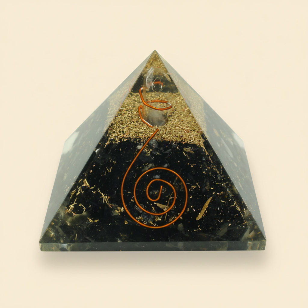 Natural 7 Chakra crystal pyramid with dark crystal tones and gold-toned inclusions on an ivory background