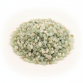 Close-up pile of Prehnite crystal chips on a light background