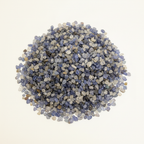 Close-up pile of Blue Sapphire crystal chips on a light background
