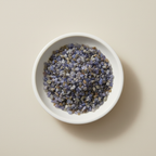 Blue Sapphire crystal chips arranged in a white ceramic dish