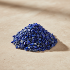 Lapis Lazuli Crystal Chips arranged on a warm neutral stone surface