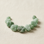 Close-up of rough mint-green and sage-green Green Aventurine Crystal Chips