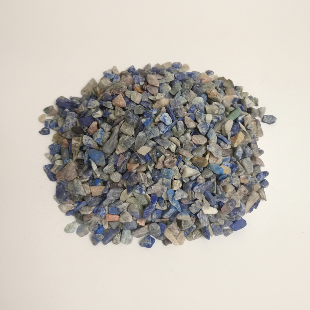 Small natural pile of Lapis Lazuli Chips on a warm studio surface