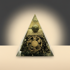 Triangular Pyrite pyramid with an embedded green-gold sphere and central coin-shaped design on a warm studio background
